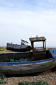 Two old blue fishing boats on the shore