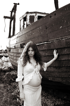 female in white lace touching fishing boat
