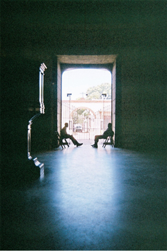 seated figures and pulpit silhouetted in cathedral doorway