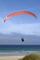 man parascending onto a beach