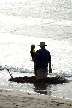Father and son make a defiant stand against the incoming tide